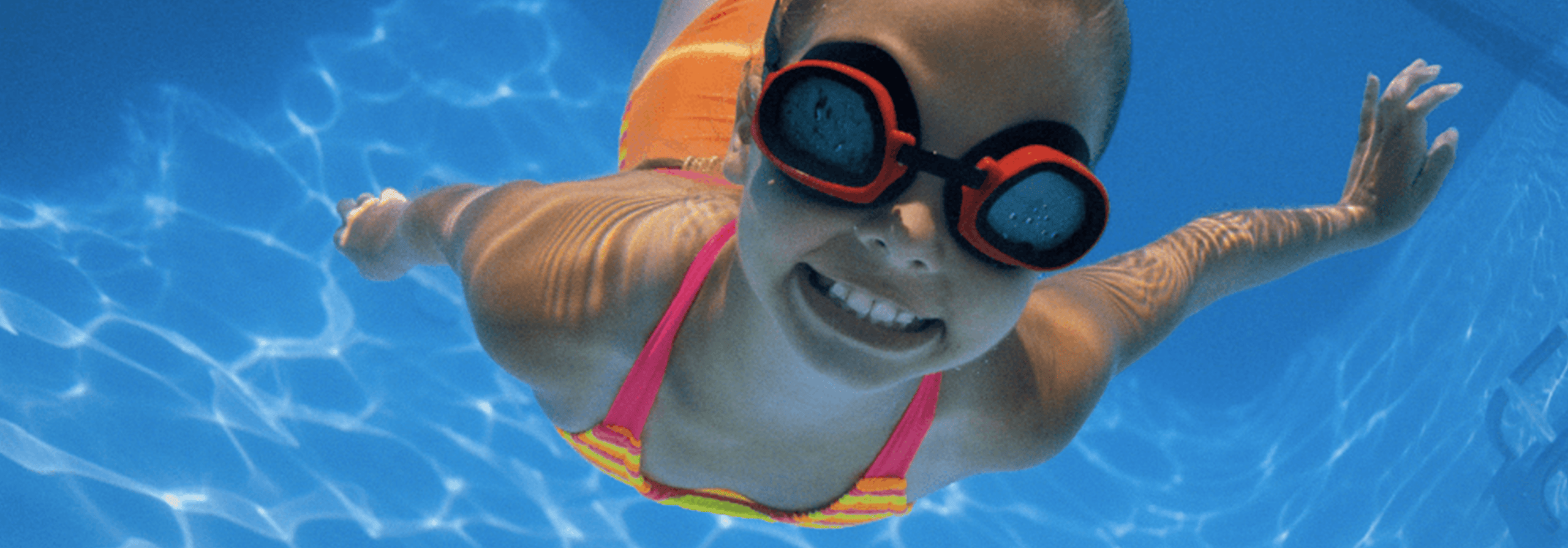 A little girl is swimming in George Ward pool in the neighbourhood of Holliston in Saskatoon