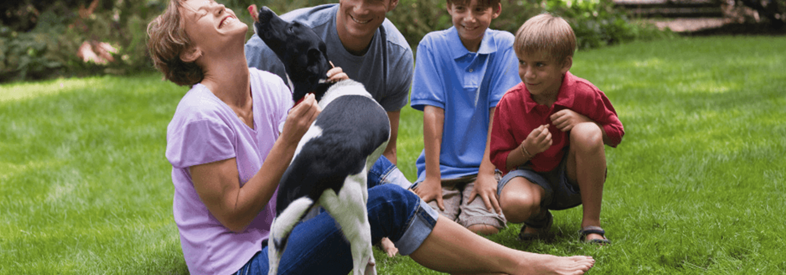 A family of kids and their dog play in the community of East College Park