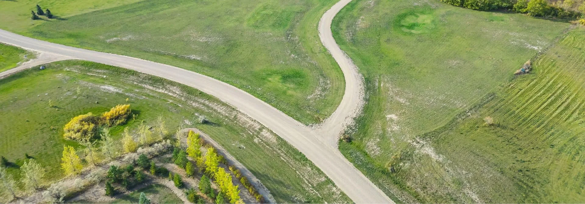 Aerial view of gravel roads winding through green farmland near Clavet, Saskatchewan